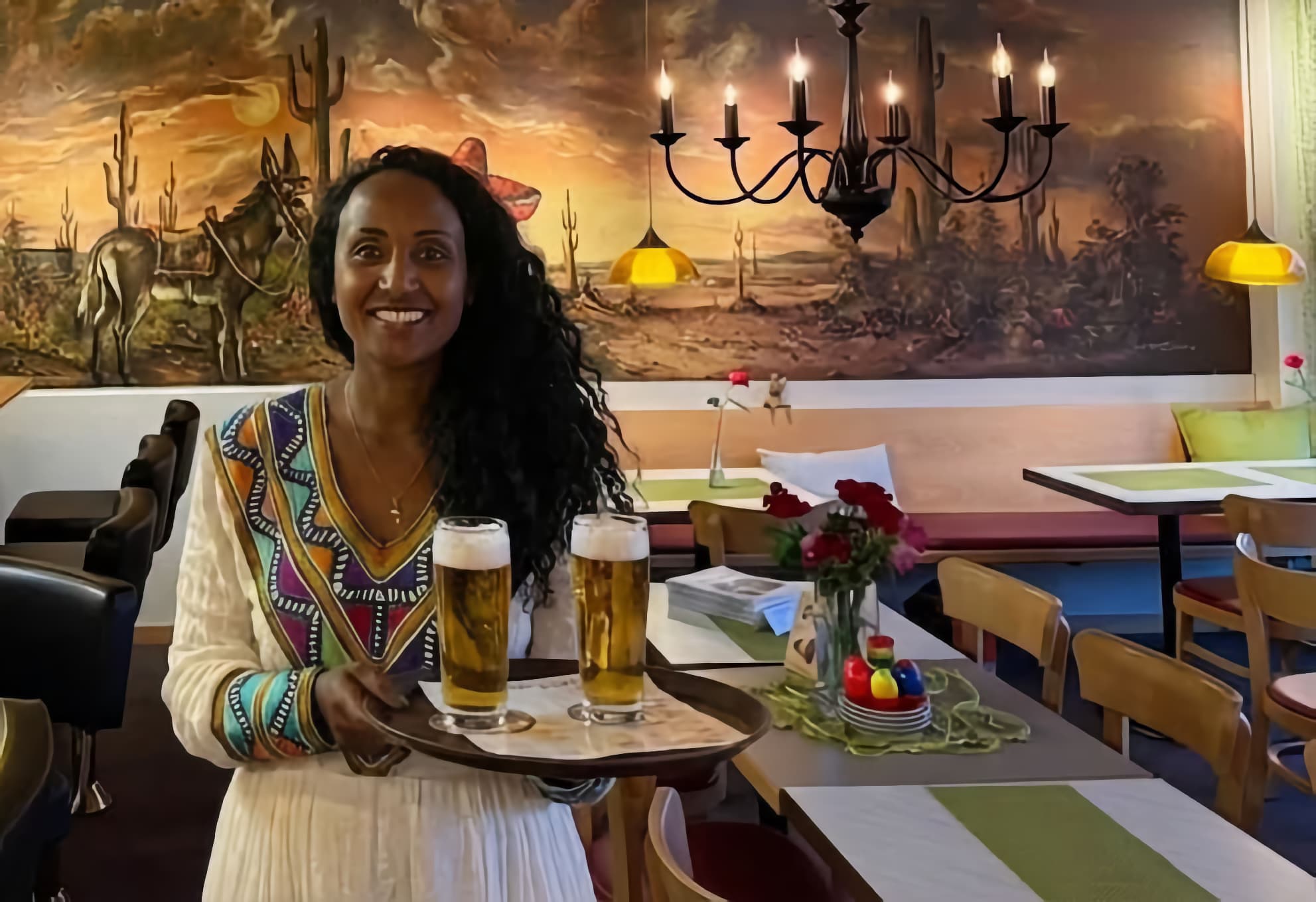 Cafe interior with mural and staff